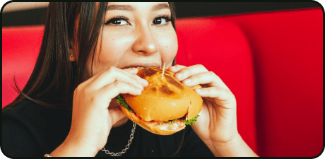 Woman biting a burger