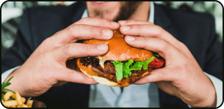 Hands holding a burger